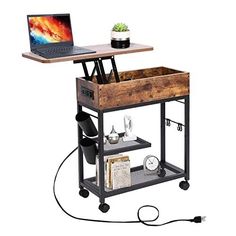 a laptop computer sitting on top of a wooden cart with wheels and shelves underneath it