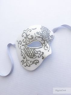 You can wear this Phantom of the Opera Musical inspired mask with comfort for long hours. Perfect for Masquerade balls, Wedding and Proms! You can pick custom color option if you would like a customized mask in a different color to match your attire/theme S H I P P I N G - Processed same day or within 24 hours. 1-2 day guaranteed delivery services offered, add items to cart and click on shipping tab for rates. Pls leave a check out note with your need date & contact number (especially for ex White Formal Masquerade Mask For Carnival, White Full Face Mask For Masquerade, Elegant White Eye Mask, White Mardi Gras Masquerade Masks And Prosthetics, White Eye Mask For Wedding, White Wedding Eye Mask, White Masquerade Masks And Prosthetics For Mardi Gras, White Masks And Prosthetics For Mardi Gras Masquerade, Adjustable Masquerade Mask For Wedding Carnival