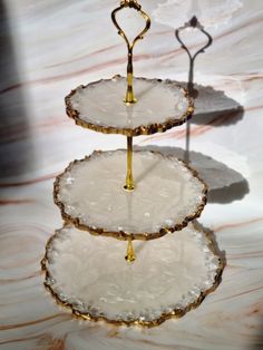 three tiered trays with white and gold decorations