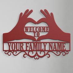 a red metal sign that says welcome to your family name with two hands holding a heart