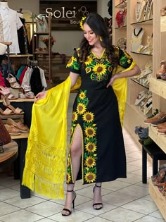 This Beautiful Mexican Sunflower Dress is the perfect dress for a special event or Mexican Fiesta. It reflects the Mexican culture through its unique design and vibrant colors. It has ties on the back for an adjustable fit and is embroidered by Artisanal Machine by Mexican Artisans in Puebla, Mexico. It's made out of fresh Mexican cotton, is full of colorful embroidered sunflowers and has some crocheted details. Mexican Theme Party Outfit, Mexican Theme Dresses, Mexican Traditional Clothing, Mexican Theme Party, Mexican Style Dresses, Mexican Sunflower, Traditional Mexican Dress, Mexican Embroidered Dress, Fiesta Dress