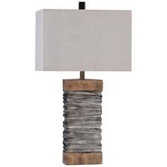 a table lamp with a wooden base and fabric shade