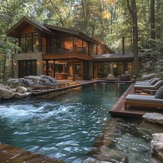 a house in the woods with a pool and lounge chairs next to it that is surrounded by trees