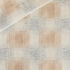 an up close shot of a tan and white checkered fabric