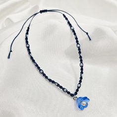 This bracelet is inspired by RM's album Indigo.  The bracelet closes with a sliding knot and is highly adjustable, tightening to 6.5 inches and extending to 11.5 inches. It is made with navy blue waxed thread, pearlescent white seed beads, and a blue flower charm with white pearl detail.  Please message me with any questions! Borahae! <3 Album Inspired Bracelets, Rm Indigo, Inspired Bracelets, Bts Rm, Sliding Knot, Acrylic Charms, Braided Bracelets, Flower Charm, Blue Flower