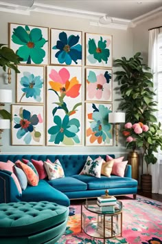 a living room filled with blue couches and colorful paintings on the wall above them