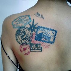 the back of a woman's shoulder with stamps on it and an airplane flying overhead