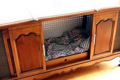 an old fashioned wooden entertainment center with drawers