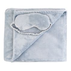 a blue blanket with a white eye mask on it