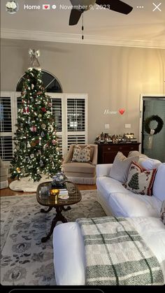 a living room filled with furniture and a christmas tree