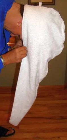 Model leaning over putting the towel wrap on Towel Headwrap, Hair Towel Pattern, Head Wrap Pattern, Turbie Twist, Hair Towel Wrap, Towel Wrap, Wrap Pattern, Spa Gift