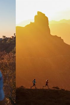 two people are running in the mountains at sunset and one is wearing a blue shirt