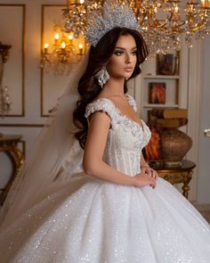 a barbie doll wearing a wedding dress and tiara in a room with chandeliers