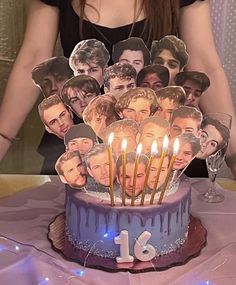 a birthday cake with candles in the shape of faces on it, surrounded by cutouts of people