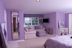 a bedroom with purple walls and white furniture