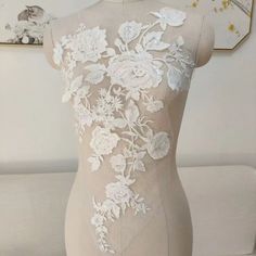 a mannequin with white flowers on it