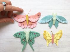 four different colored butterflies are shown in the process of being sewned and stitched together