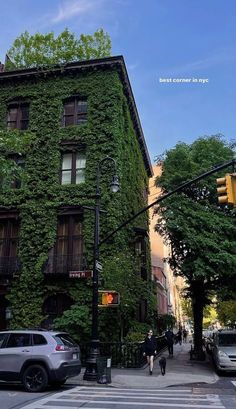 an ivy covered building on the corner of a street