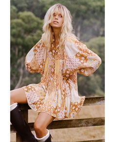 The gorgeous Freda Boho Mini Dress is a new take on our classic Boho shape. This beguiling mini oozes of 1970’s influences from the signature patchwork print of blooming flowers spread across its incredibly voluminous silhouette to its stunning earthy, amber tones. This Boho Mini is versatile with a button through neckline that allows for both a relaxed or more demure look that’s perfect to take you from brunch to bar. With incredible billowing sleeves that have been inserted low into the yolk, Traditional Boho, Spell Designs, Boho Mini Dress, Patchwork Print, Organic Cotton Fabric, Blooming Flowers, Unique Print, Off Shoulder Dress, Boho Fashion