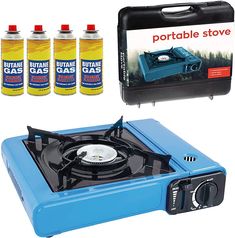 the portable gas stove is blue and has four bottles next to it