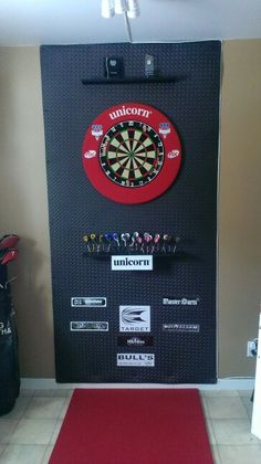 a dart board mounted to the side of a door with darts on it and other items