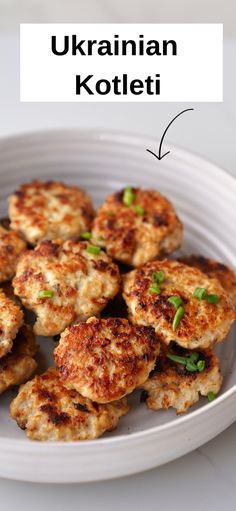 a white plate topped with crab cakes and green onions