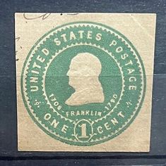 an old postage stamp with the head of a man in green and white on it