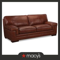 a brown leather couch sitting on top of a white floor next to a red star