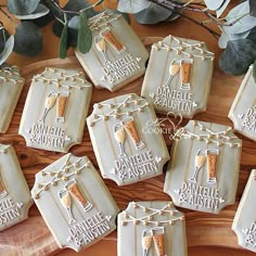 decorated cookies are arranged on a wooden platter