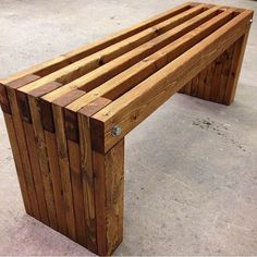 a wooden bench sitting on top of cement ground