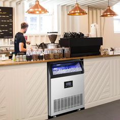 a person standing at a counter in a coffee shop