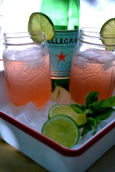 two mason jars filled with lemonade and limes