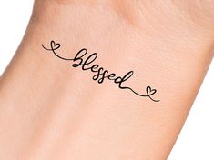 a hand with a tattoo on it that says, blessed