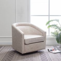 a chair sitting in front of a window next to a plant