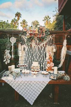 a table topped with cake and cupcakes on top of a wooden table