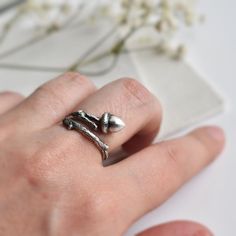 Acorn and twig adjustable ring. It is a wonderful gift for a nature lover. And it's all right if you don't know the exact size, the ring is adjustable a few sizes up or down starting for the size you order. The ring is 925 silver. We don't keep an active stock, we simply make them in your size(s) as we receive the order. We can also leave the back of the ring open so you can adjust it. If you want them adjustable, please specify so in your message. The items we sell are entirely handmade in our Acorn Jewelry, Measure Ring Size, Twig Ring, Tarnished Silver, Botanical Jewelry, Jewelry Studio, Ring Sizer, Adjustable Ring, Ring Silver