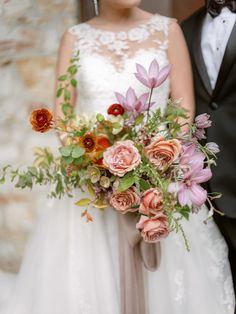 a bride and groom standing next to each other