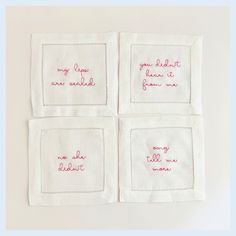 four embroidered napkins with words on them