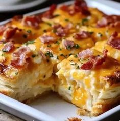 a close up of a plate of food with cheese and bacon on it's side