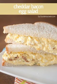 a close up of a sandwich on a plate with the words cheddar bacon egg salad