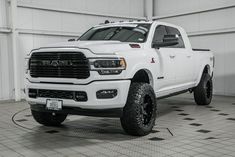 a white ram truck parked in a garage