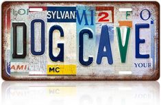 a license plate with the word dog cave on it's front and back sides