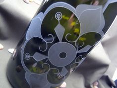 a close up view of a black vase with flowers on the inside and in the outside