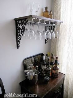 there is a shelf with wine glasses on it