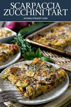 a slice of zucchini tart on a white plate with a fork next to it