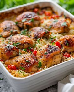 a casserole dish with chicken and rice topped with parsley garnish