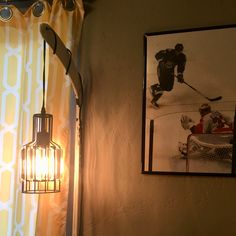 an image of a hockey game being played on the wall next to a window with curtains