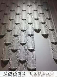 an image of a wall that has been made out of white paper with wavy lines on it