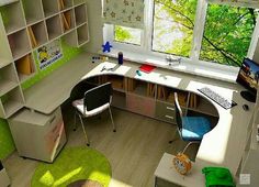 a computer desk sitting next to a window in a room with lots of bookshelves