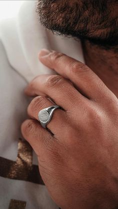 a close up of a person wearing a ring